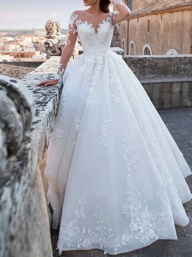 Back view of the elegant ball gown wedding dress showcasing the chapel train and lace details.