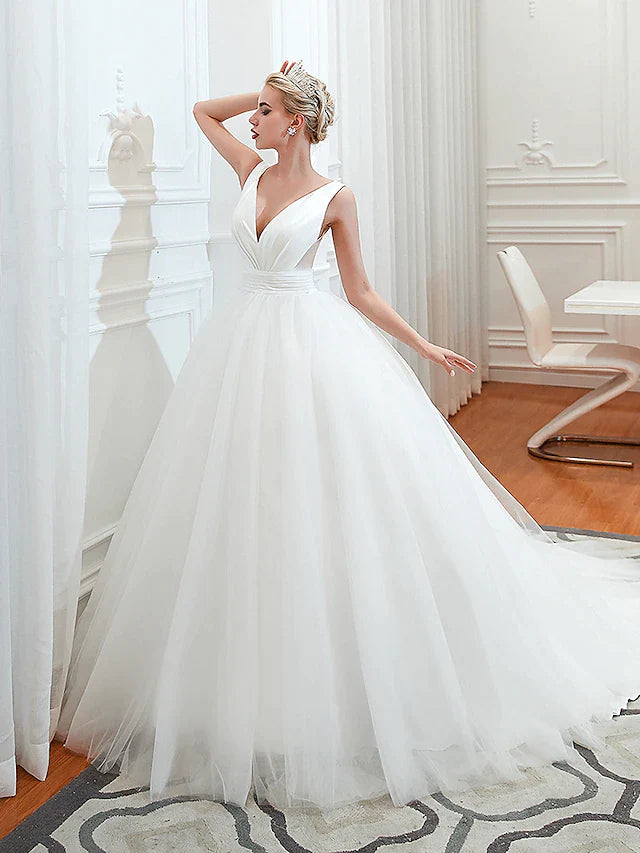 Back view of the wedding dress, showing backless design and ruched details.