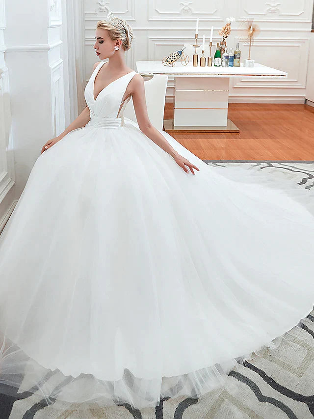 Close-up of the V-neckline and regular straps on the tulle wedding dress.