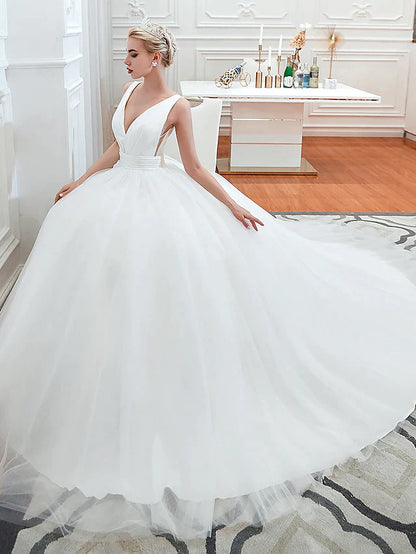 Close-up of the V-neckline and regular straps on the tulle wedding dress.