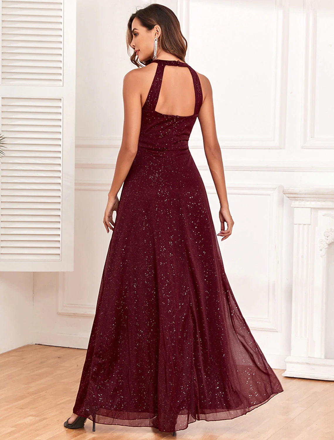 Close-up of the glitter fabric and elegant halter neckline of the evening dress.