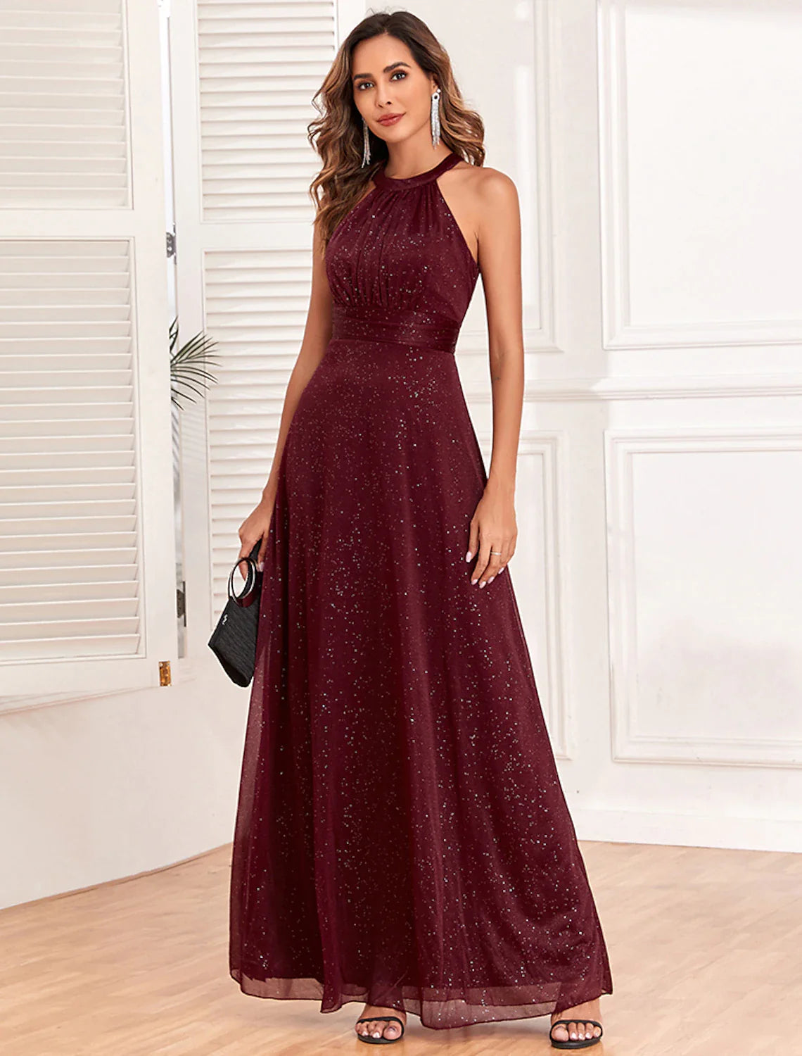 Side profile of a woman in the sparkling A-line empire evening dress.