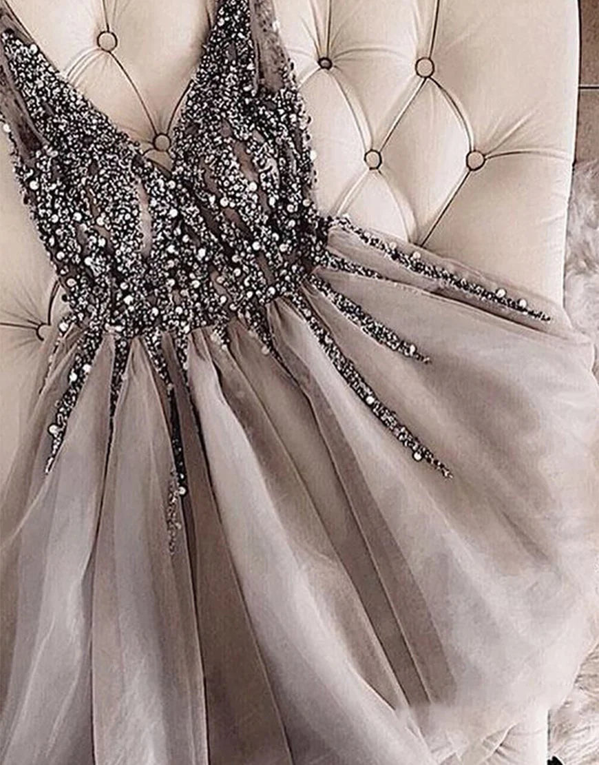 Back view of a short A-line glitter homecoming dress with pleated skirt.