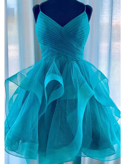 Back view of a woman in a glittery A-line tiered plisse short dress, showcasing ruched details.