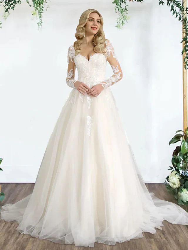Bride wearing an A-Line sweetheart lace tulle wedding dress with appliques and pleats.