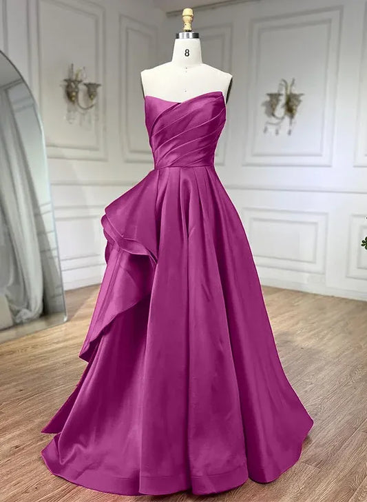 Model wearing a magenta A-line strapless pleated ruffled satin floor-length prom dress, front view.