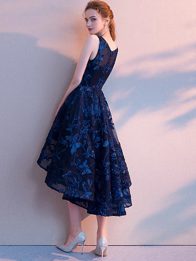 Side view of a woman in a sophisticated A-line tulle party dress with an asymmetrical hem.