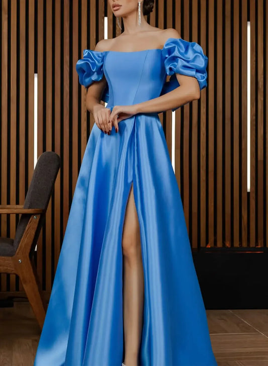 Model wearing an ocean blue satin A-line prom dress with off-shoulder puff sleeves and a high slit, posing elegantly.