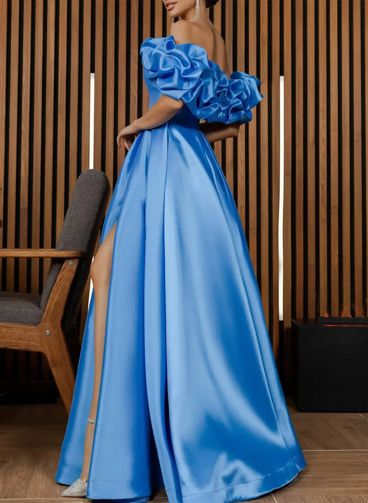 Back view of an ocean blue satin A-line prom dress, highlighting the off-shoulder design and flowing skirt.