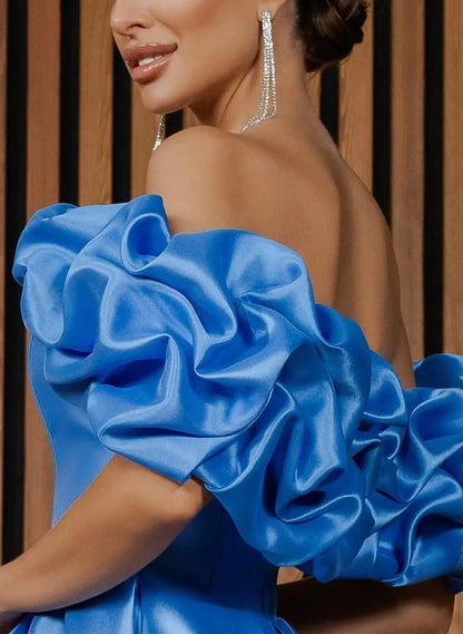 Full length view of an ocean blue satin prom dress, showcasing the high slit and A-line silhouette.