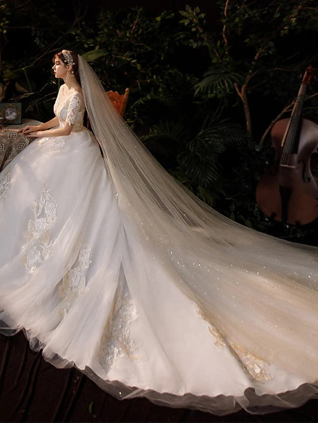 Full view of a bride in a white princess ball gown, emphasizing the elegant silhouette and flowing train.
