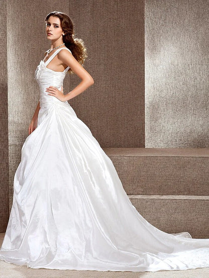 Close-up of the one-shoulder neckline and bodice details of the wedding dress.