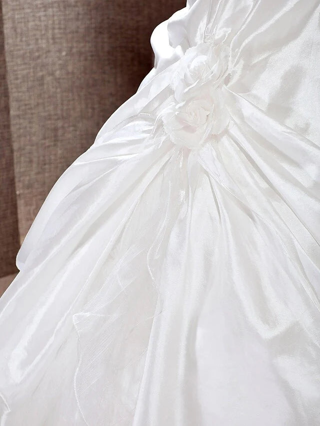 Detailed view of the taffeta fabric and the A-line skirt of the bridal gown.