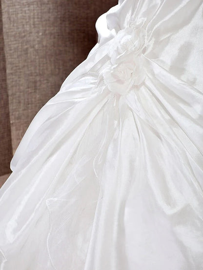 Detailed view of the taffeta fabric and the A-line skirt of the bridal gown.