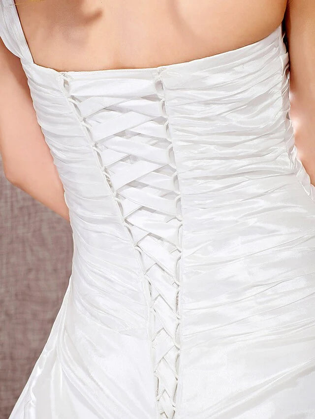 Elegant back view of the wedding dress, showing the train gracefully spread.