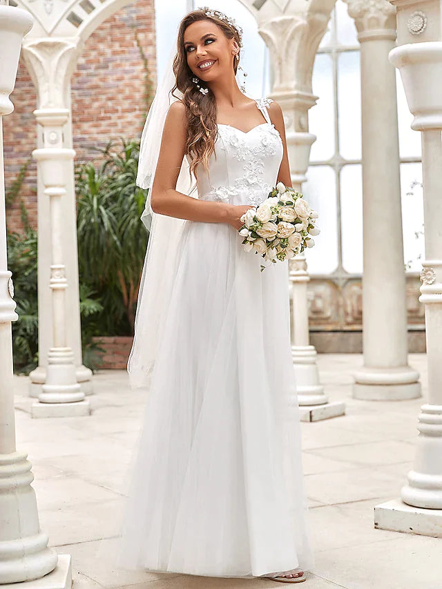 A-line wedding dress with sweetheart neckline, lace bodice, and flowing tulle skirt.