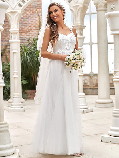 A-line wedding dress with sweetheart neckline, lace bodice, and flowing tulle skirt.