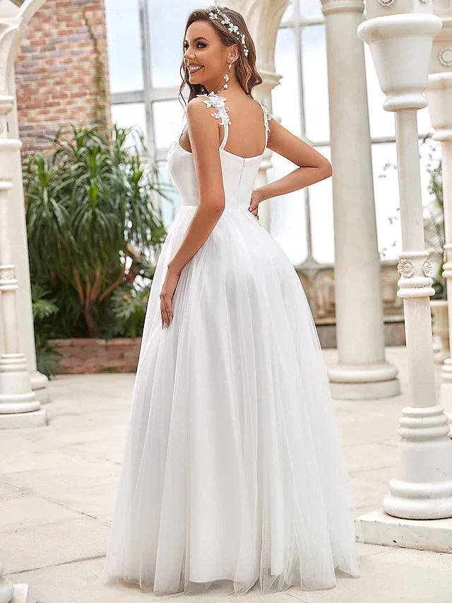 Side view of a romantic A-line bridal gown with delicate lace appliques.