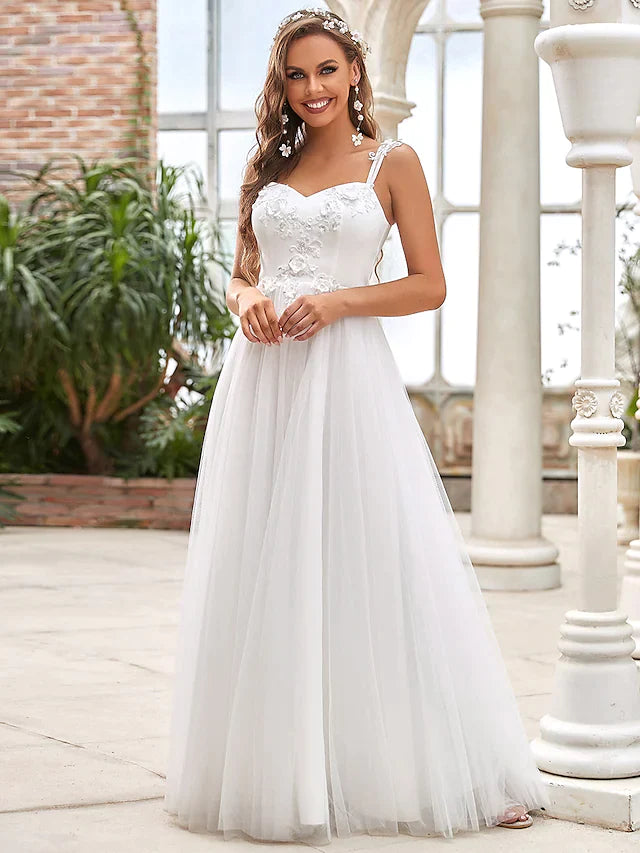 Back view of a floor-length wedding dress, showcasing the lace detailing and elegant train.