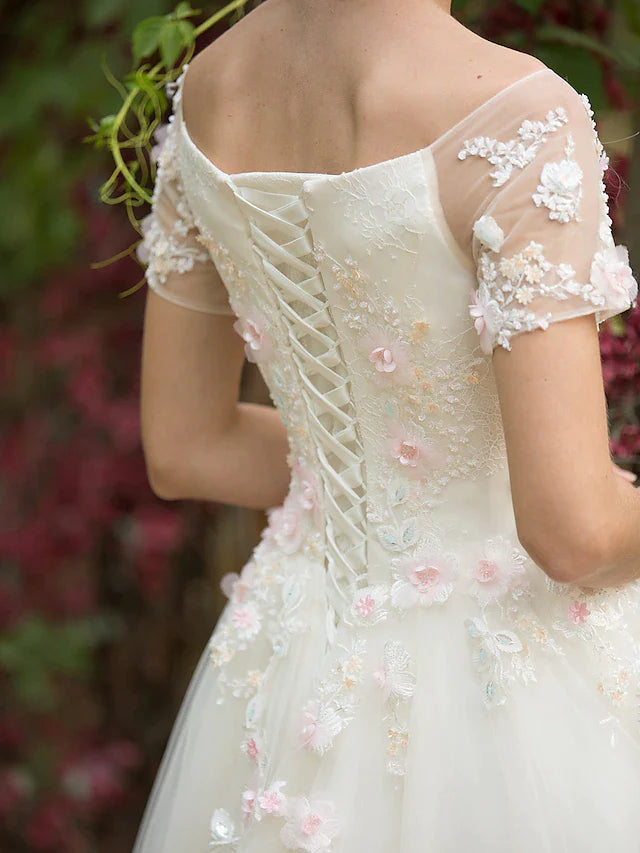 Back view of the elegant A-line wedding gown with a flowing train.