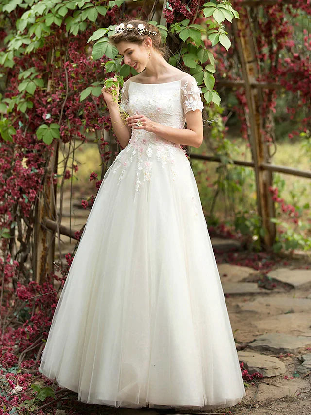 Detailed view of floral appliques and beading on the bodice of the bridal gown.