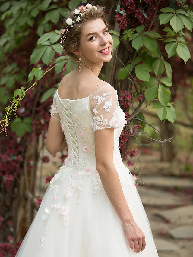 Model gracefully posing in the romantic A-line wedding dress.