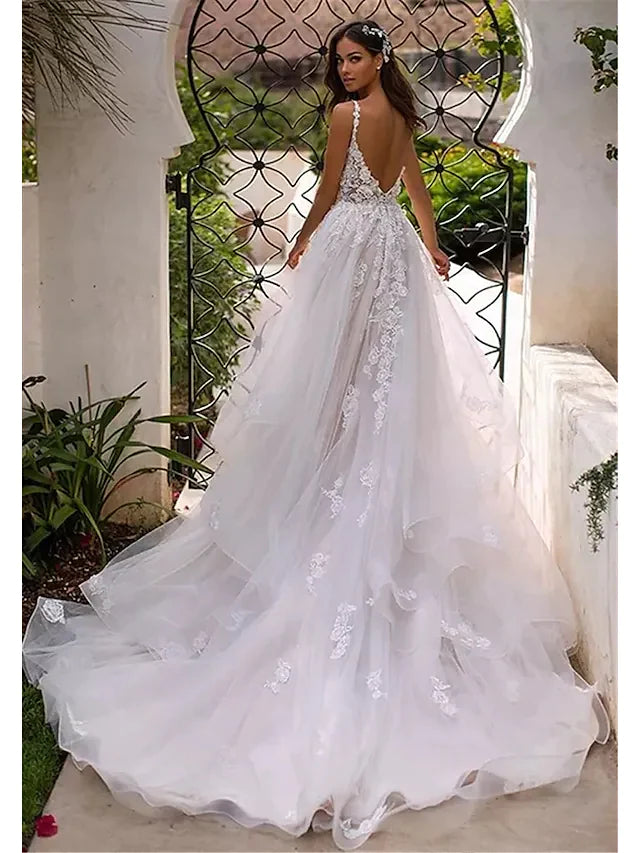 Back view of A-line V-neck wedding dress, showcasing appliques and chapel train.