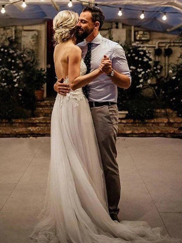 Back view of an A-Line wedding dress, showcasing the simple backless design and long train.
