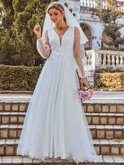 Front view of a romantic A-Line V-neck sleeveless wedding dress with lace and tulle.