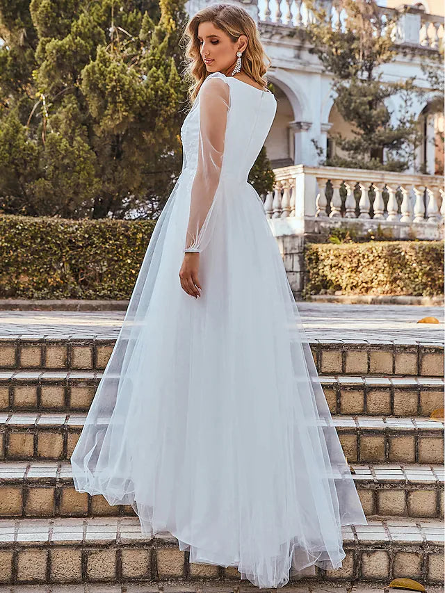 Side view of an A-Line wedding dress, showing the flowing tulle skirt and pleats.