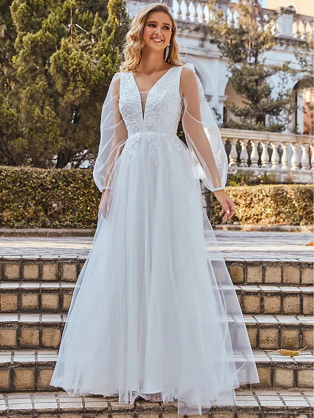 Close-up of intricate lace detailing and soft tulle fabric on the wedding dress.