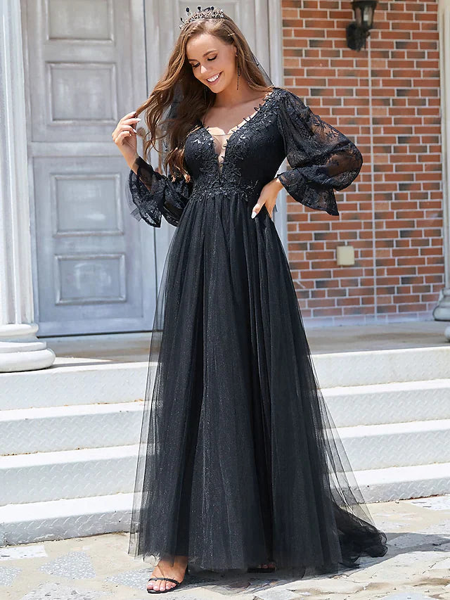 Model in a black A-line wedding dress with V-neck, lace long sleeves, and pleated tulle skirt.