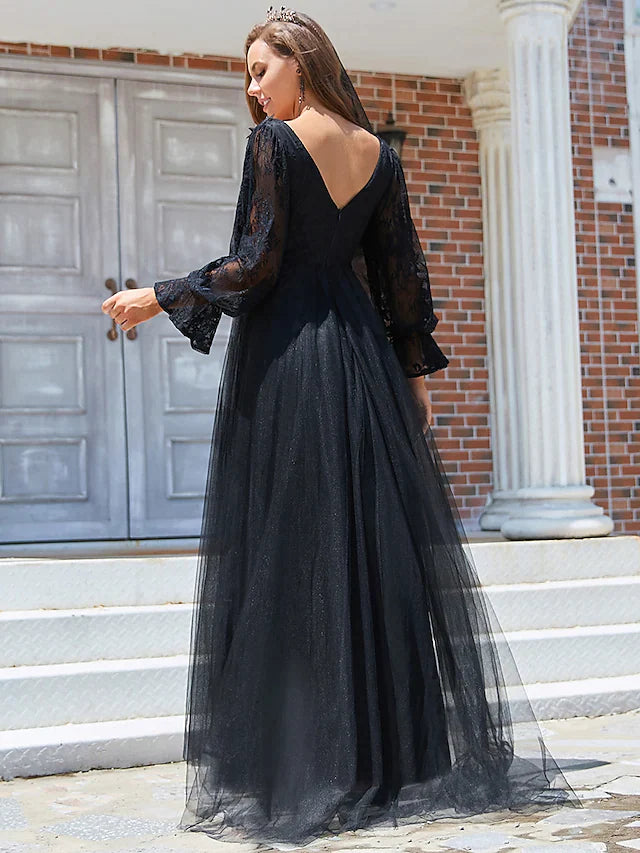 Close-up of the black A-line wedding dress bodice, featuring lace long sleeves and V-neck.