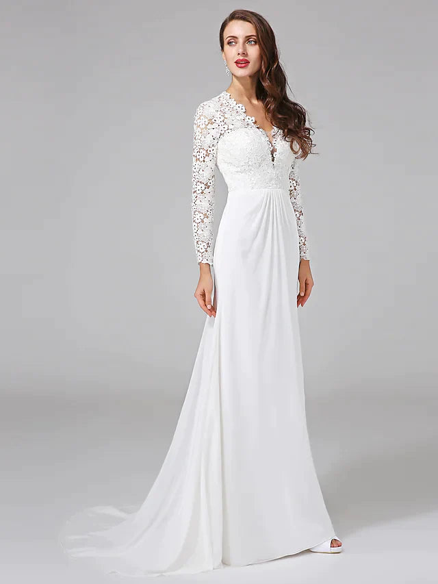 Side profile of a bride in the romantic chiffon wedding dress, highlighting the elegant long illusion sleeve.