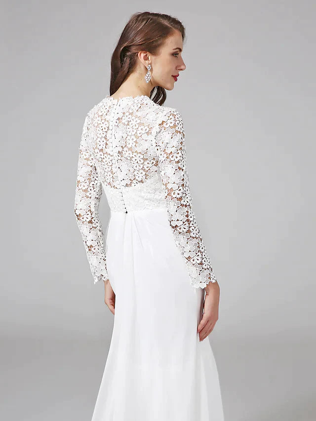 Detailed view of the exquisite floral lace pattern on the illusion sleeve and bodice of the bridal gown.
