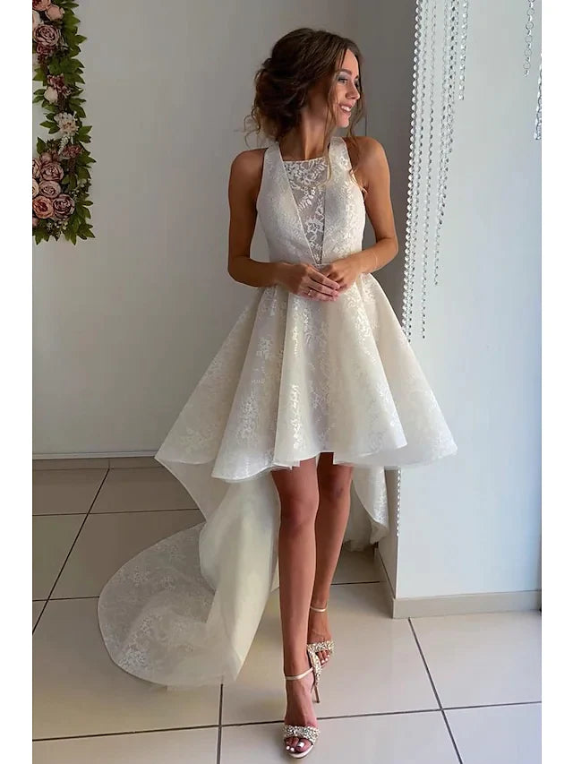 Front view of an A-Line wedding dress with jewel neck, lace appliques, and asymmetrical knee-length hem.