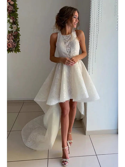 Front view of an A-Line wedding dress with jewel neck, lace appliques, and asymmetrical knee-length hem.