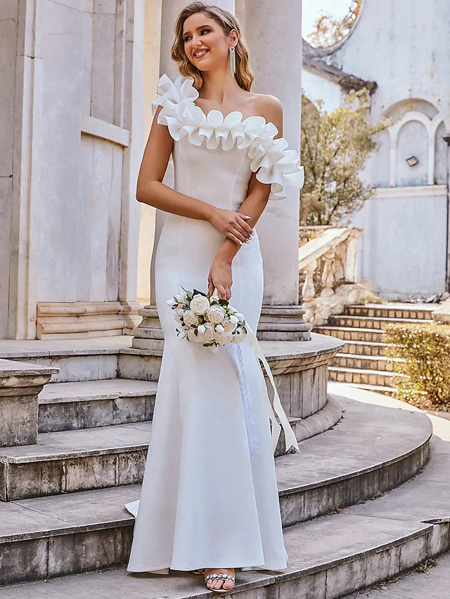 Side profile of a romantic bridal gown featuring cap sleeves and flowing skirt.