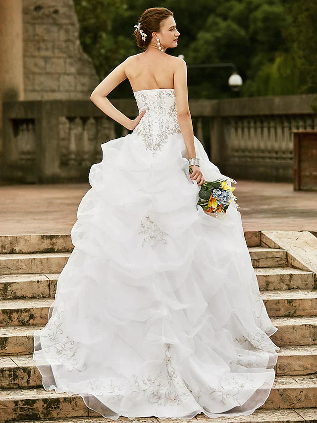 Close-up of intricate embroidery on the bodice of the wedding dress.