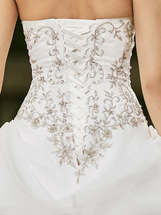 Full length view of a beautiful strapless wedding dress for brides.