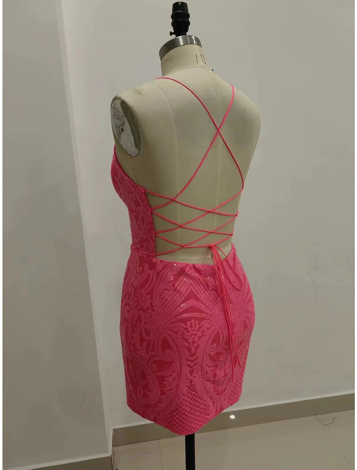 Back view of the sequined mermaid V-neck short homecoming dress with strappy details.