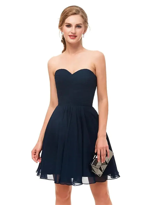 Model wearing a black A-line strapless knee-length cocktail dress.