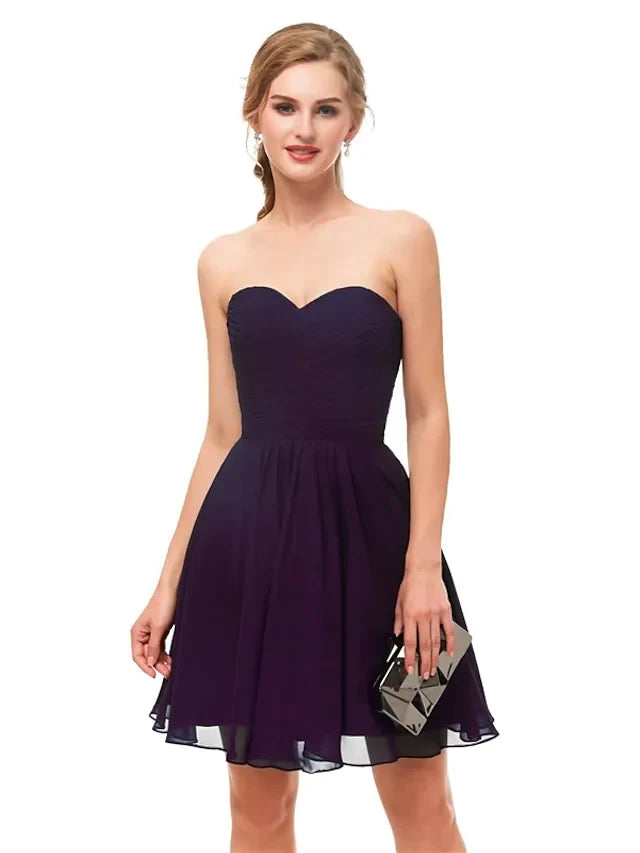 Close-up of the stretch fabric on a black A-line cocktail dress.
