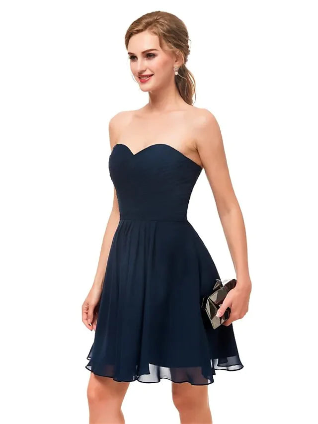 Back view of a model wearing a black A-line strapless dress.