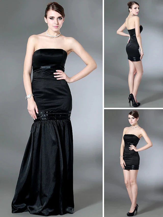 Full-length view of a woman wearing a dark strapless open-back formal evening dress.