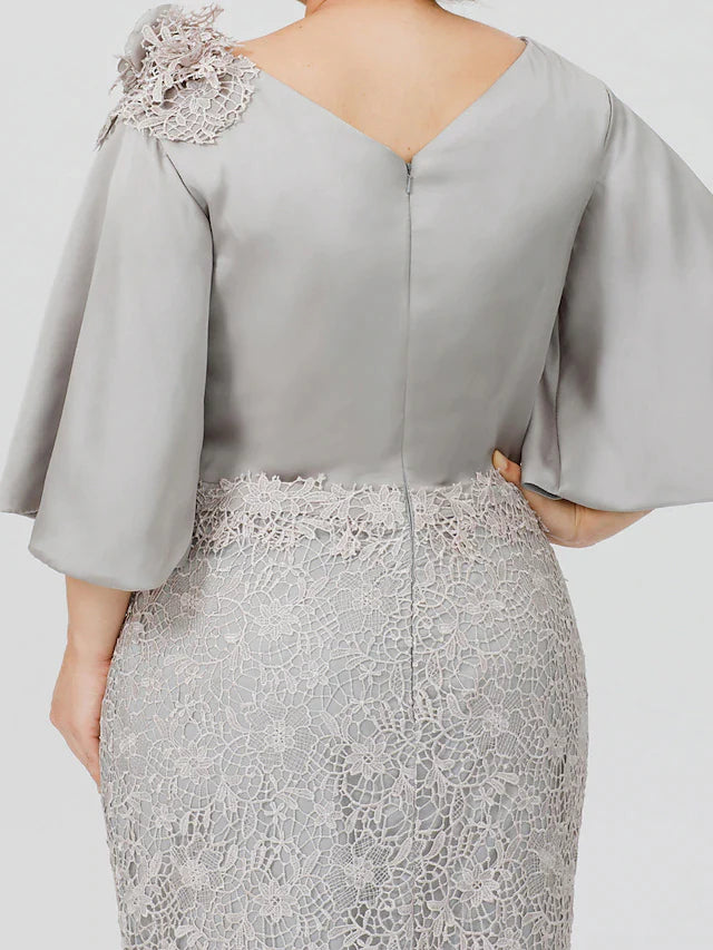 Close-up of lace appliques on the bodice of a satin dress.
