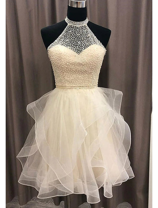 Woman in sparkling A-line halter mini homecoming dress, front view.