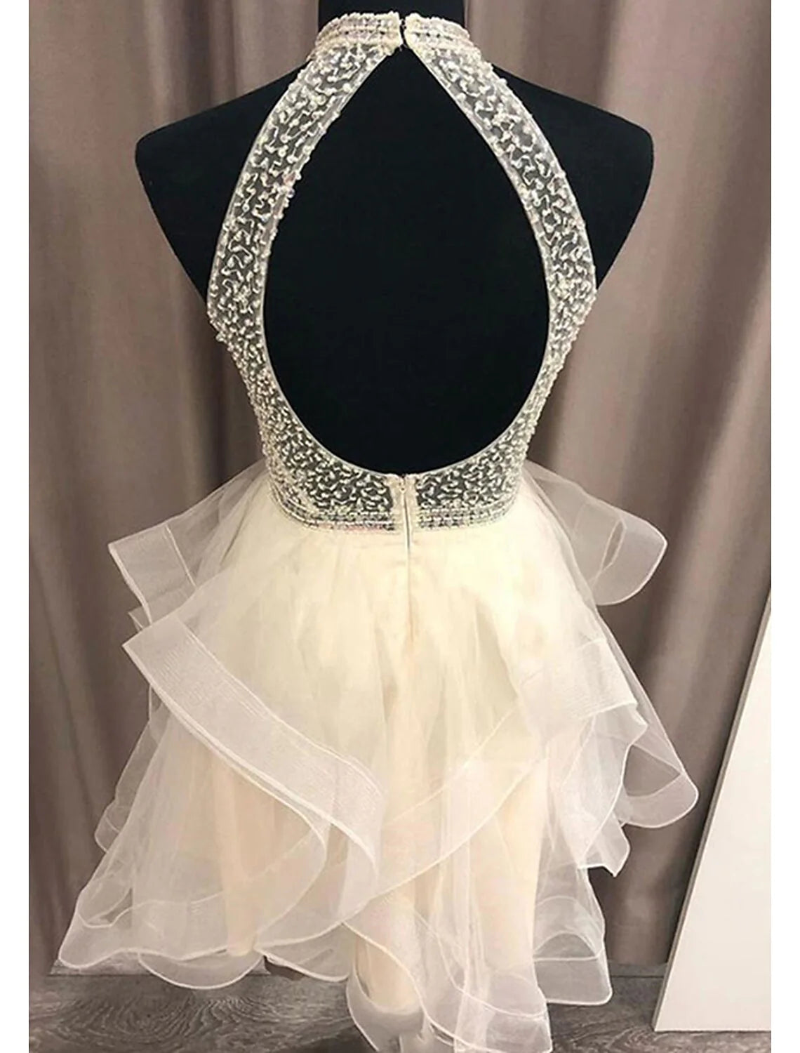 Back view of sparkling A-line halter mini homecoming dress.