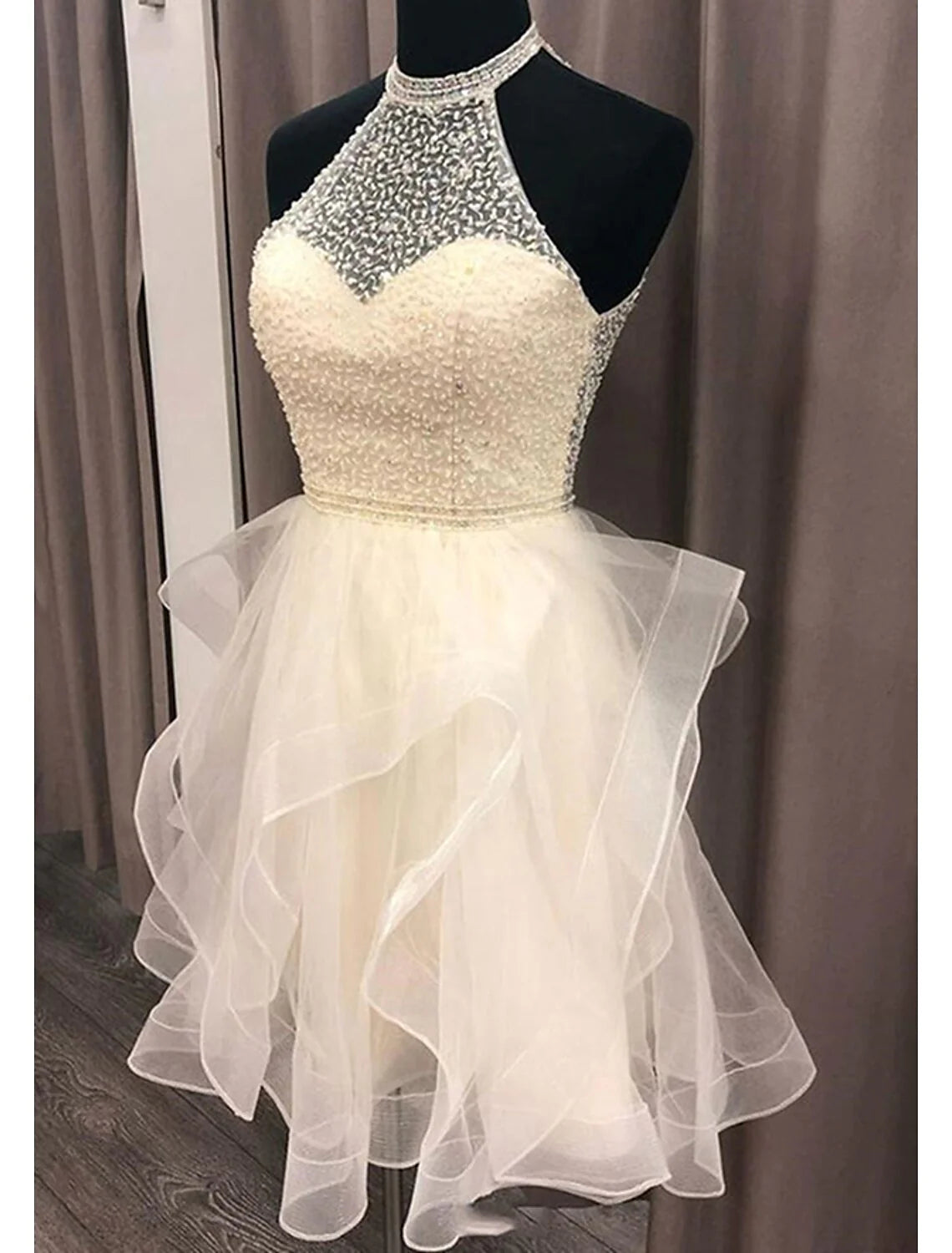 Side view of sparkling A-line halter mini homecoming dress.