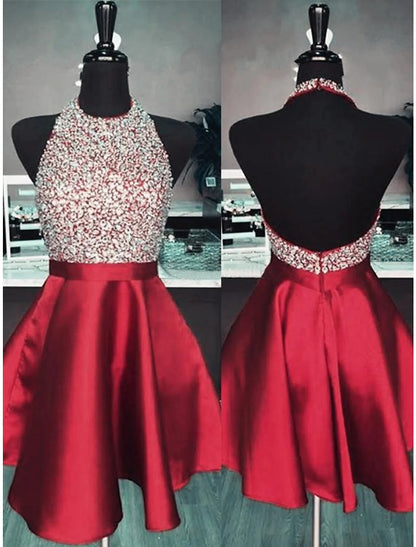 Back view of a woman in a sequined A-line halter dress, highlighting the open back.